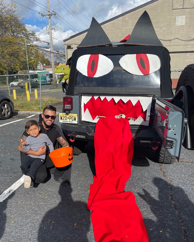 A Jeep decorated as a monster with eyes, teeth and a long red tongue