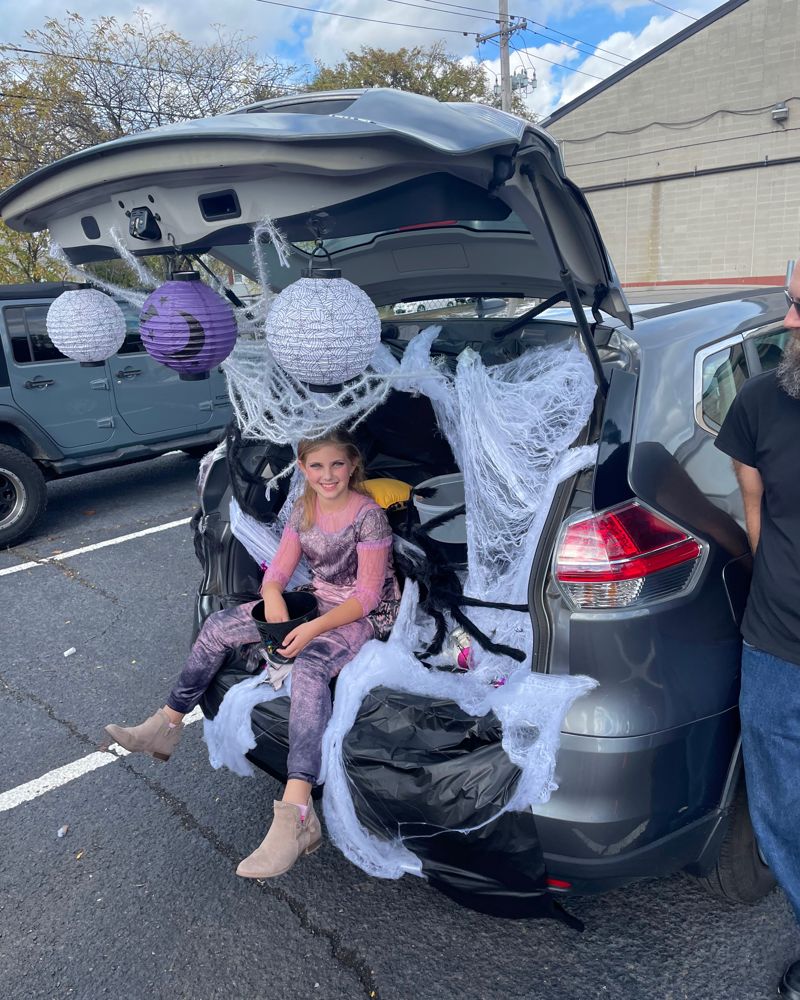 A trunk covered in spider webs and paper lanterns